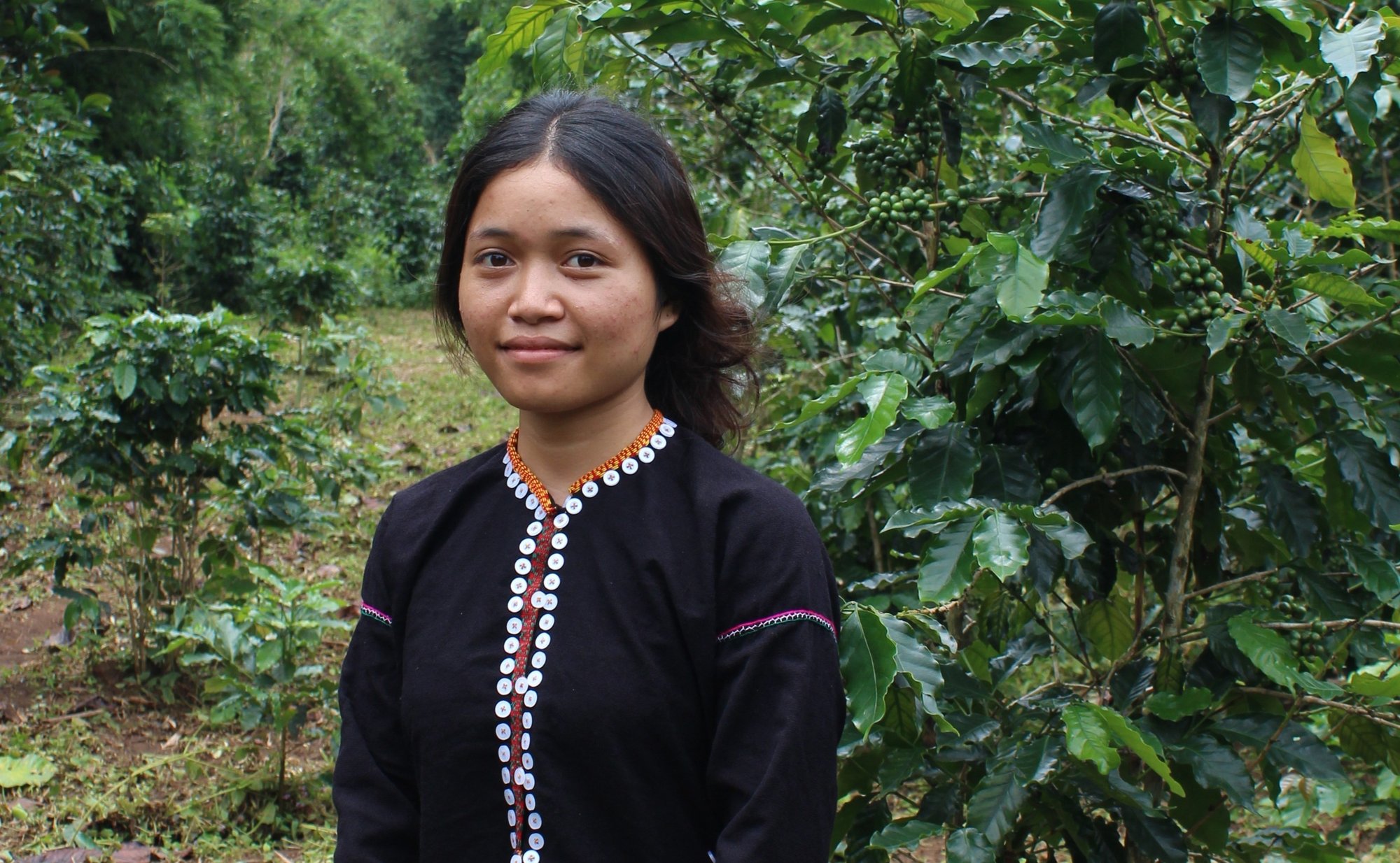 Vietnamese coffee farmer Ho Thi Hong stands on her one-hectare plot in Quang Tri, where she is starting agroforestry under the Prosperous Farmers and Forests Partnership.